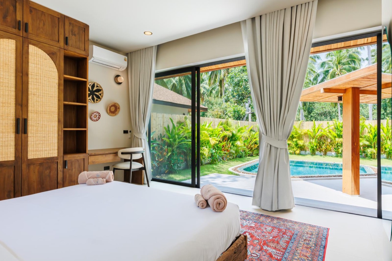 Bedroom opening directly onto the private pool and tropical garden